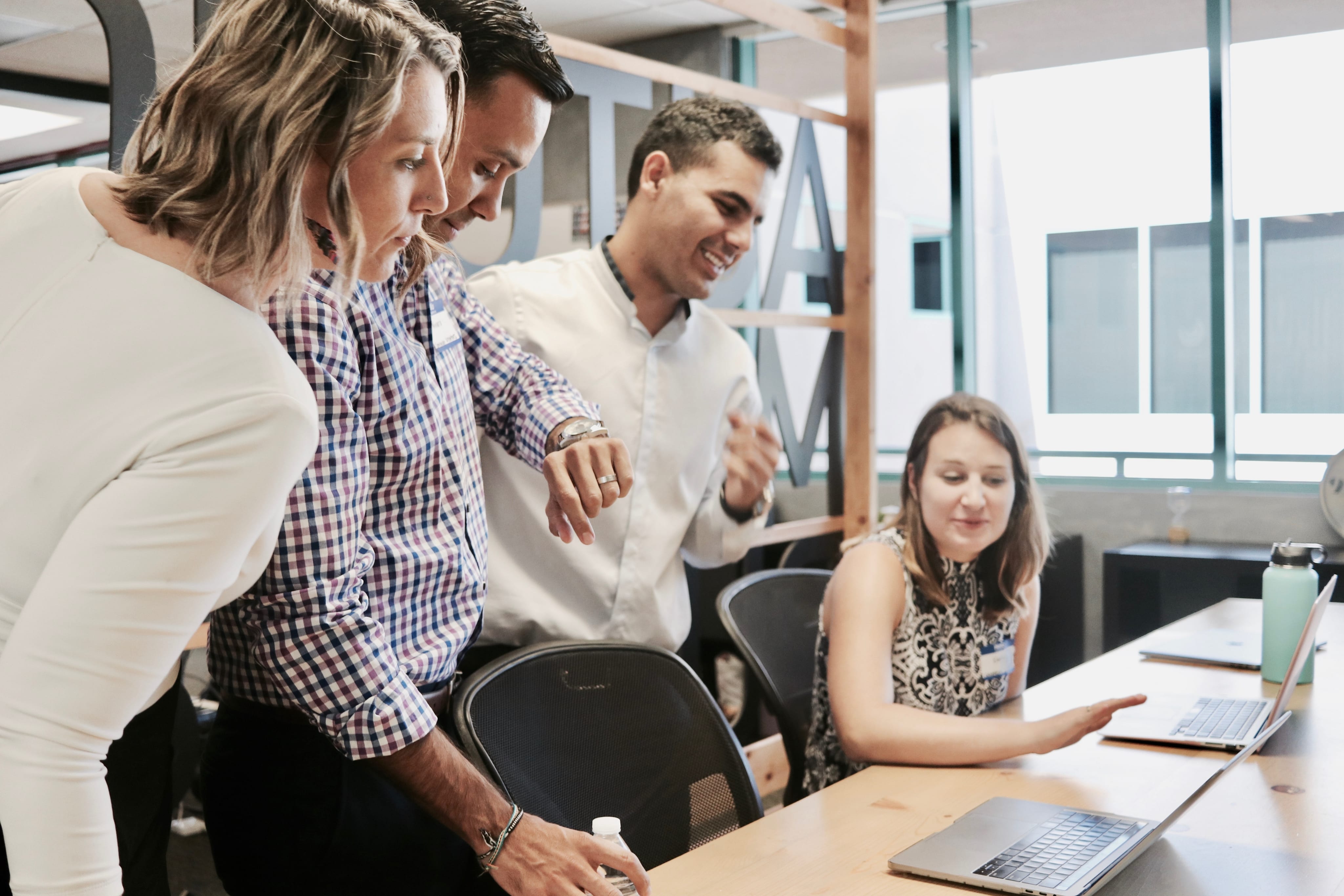 Group of people staring at a laptop
